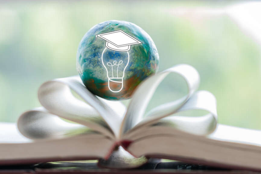 A bulb inside the globe and placed in the center of an open book representing the art of effective studying