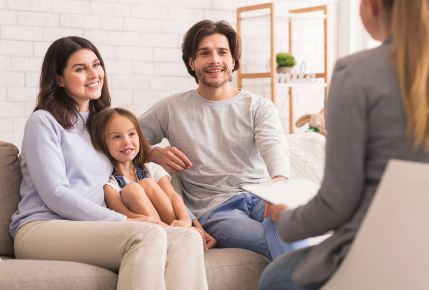 Parents with their child having a conversation with the teacher representing the concept of parent-teacher partnership