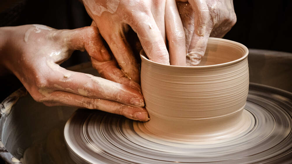 Dirt on hands while make pottery depicting the beauty of dirty hands